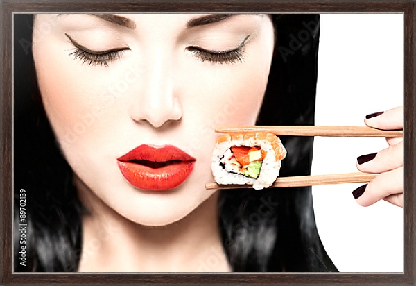 Постер Девушка ест нигири суши палочками для еды с типом исполнения На холсте в раме в багетной раме 221-02
