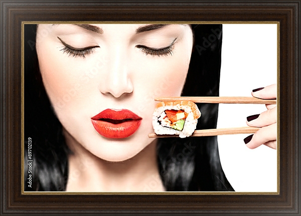 Постер Девушка ест нигири суши палочками для еды с типом исполнения На холсте в раме в багетной раме 1.023.151