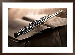 Флейта и тетрадь с нотами в раме под стеклом